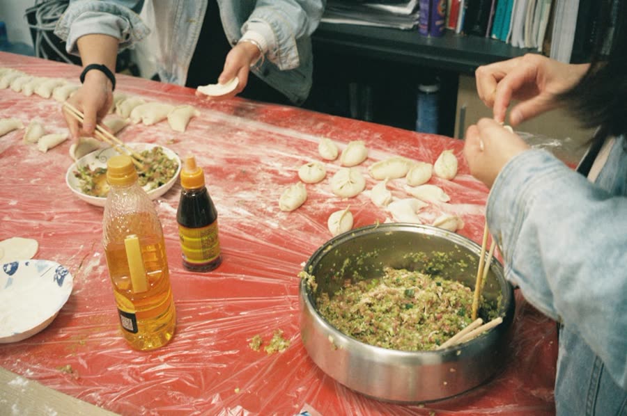 Roommates folding dumplings together at a table