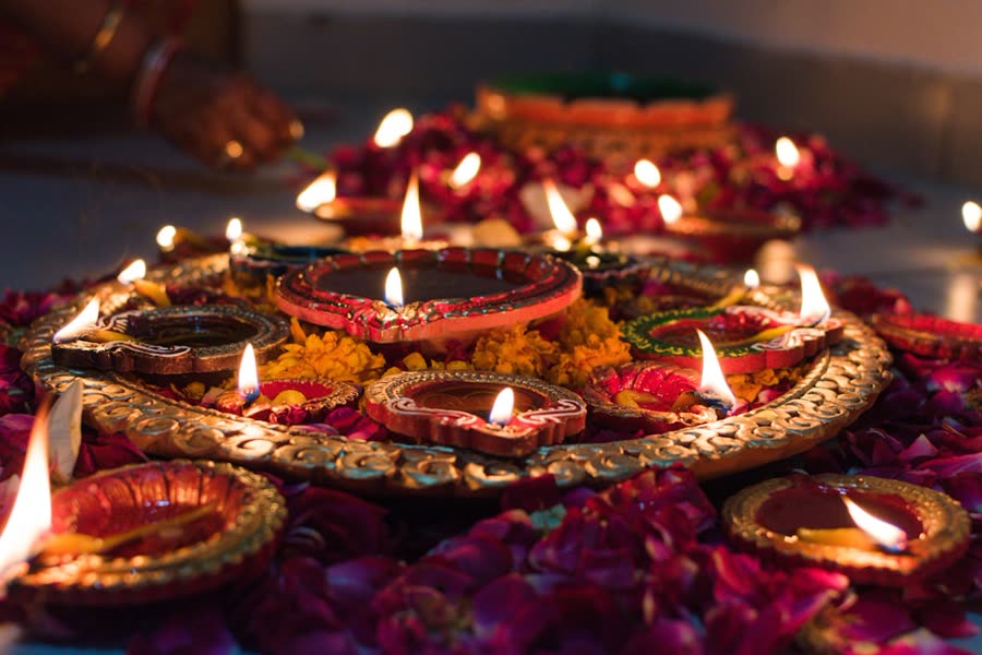 Lit Diwali diyas arranged on a decorated plate