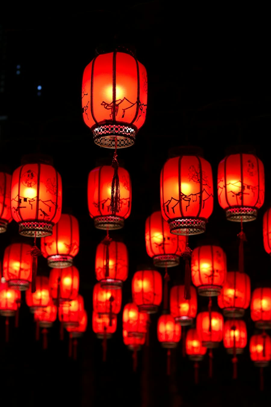 Rows of glowing red lanterns at night for Lunar New Year